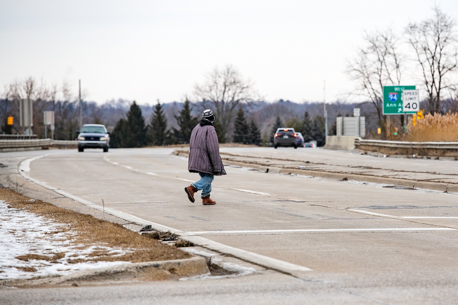 Qunitez Tomlin uses the Huron Street median to cross I-94.