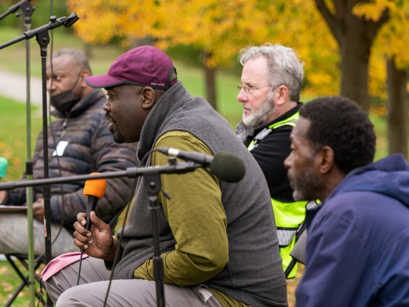 Shamar Herron (in red cap) speaks, surrounded by Nate Frazier, Paul Hickman, and Melvin Parson.