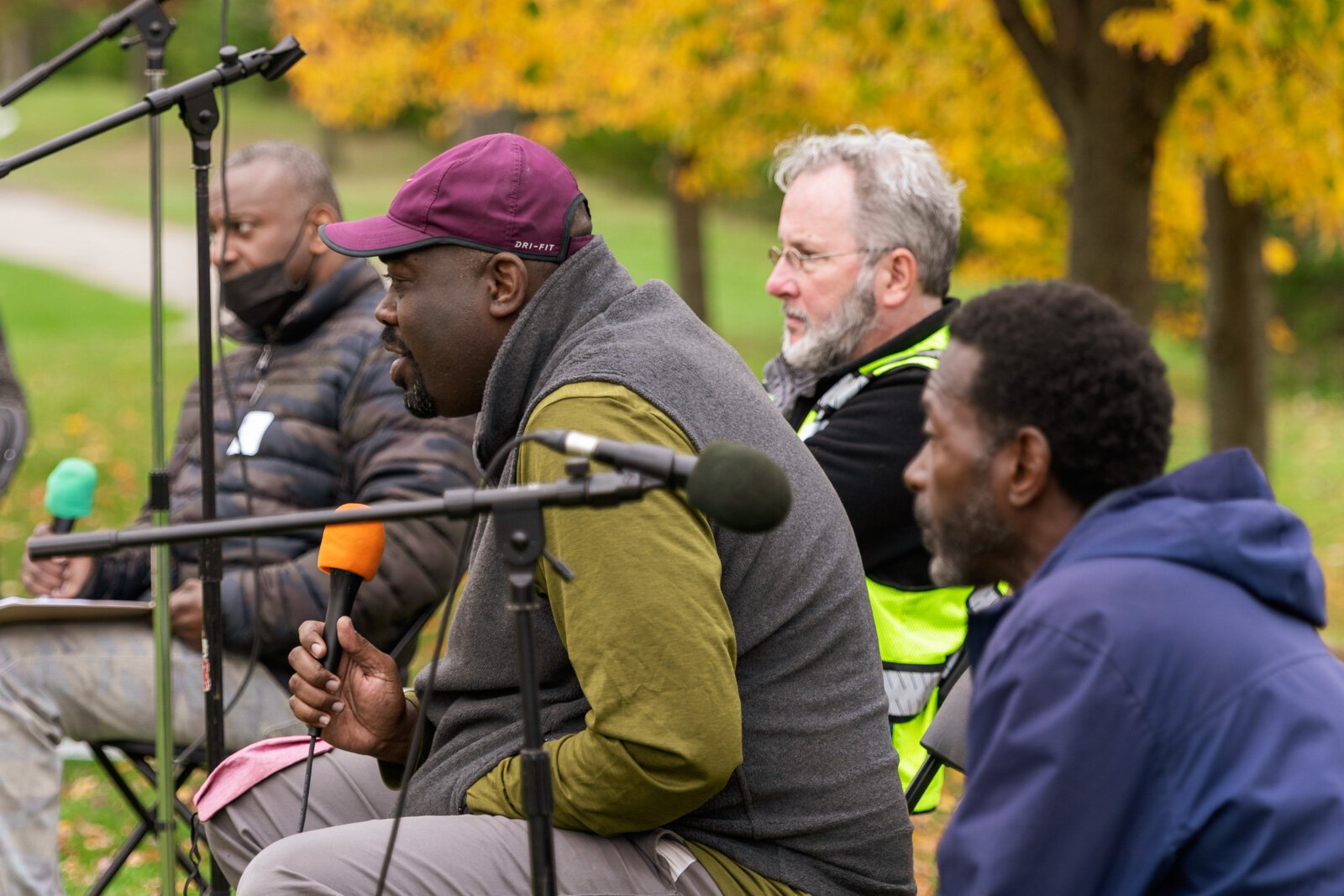Shamar Herron (in red cap) speaks, surrounded by Nate Frazier, Paul Hickman, and Melvin Parson.