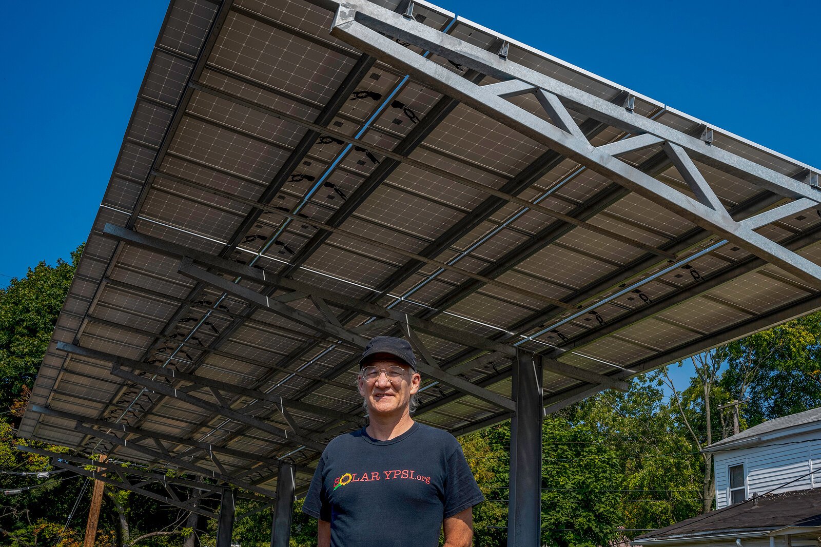 Dave Strenski in front of a solar installation at the Thompson Block in Ypsilanti.