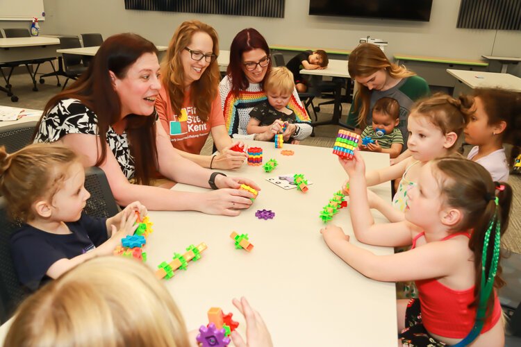 Shelley Roossien, Accessibility and Inclusion Specialist at KDL, leads children through a building exercise.
