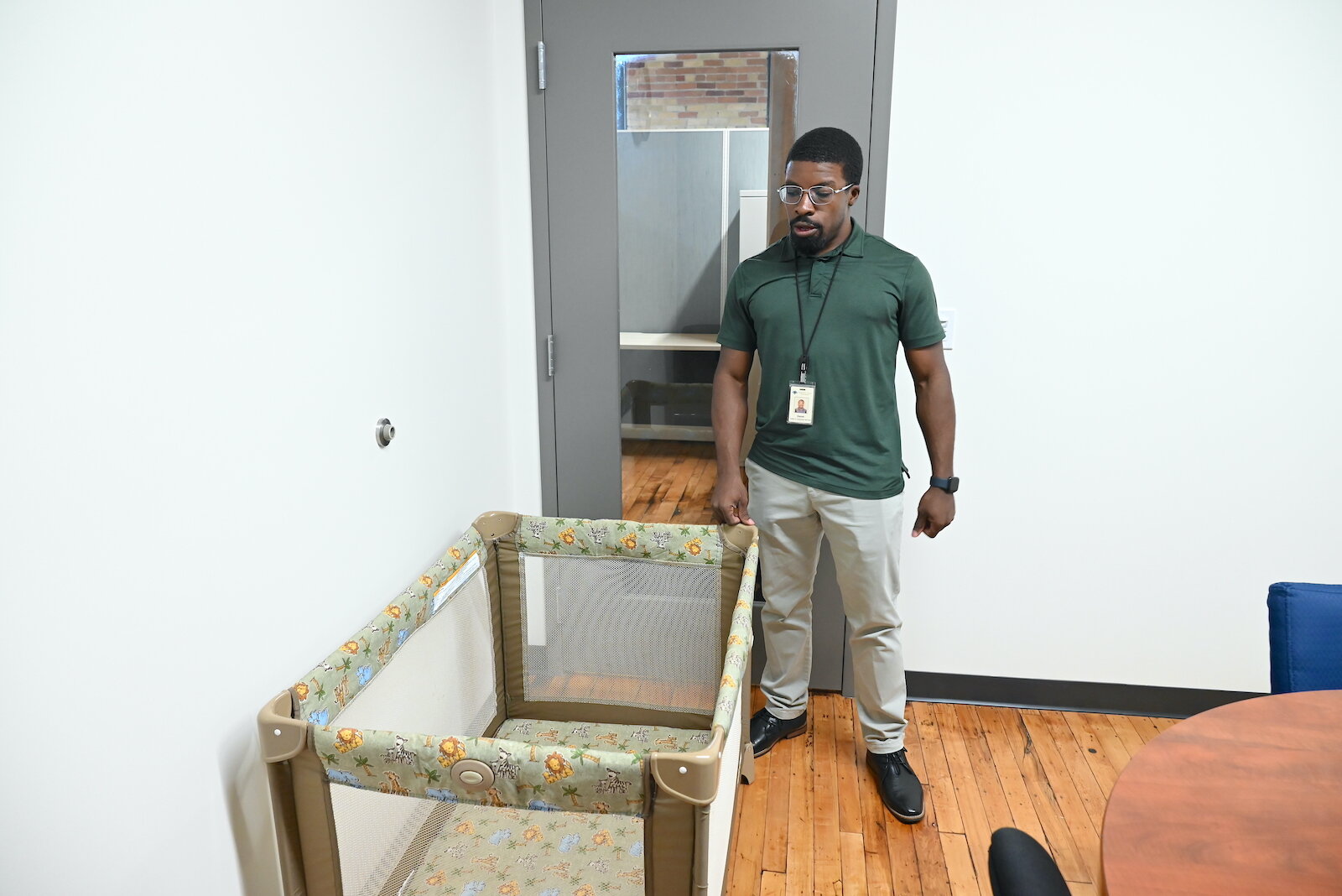 Derek Miller with a Pack 'n Play playpen, which Kalamazoo County has given away to families.