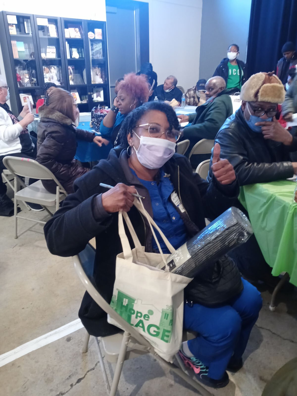 A Citizenship for Health event participant shows off exercise equipment she won.