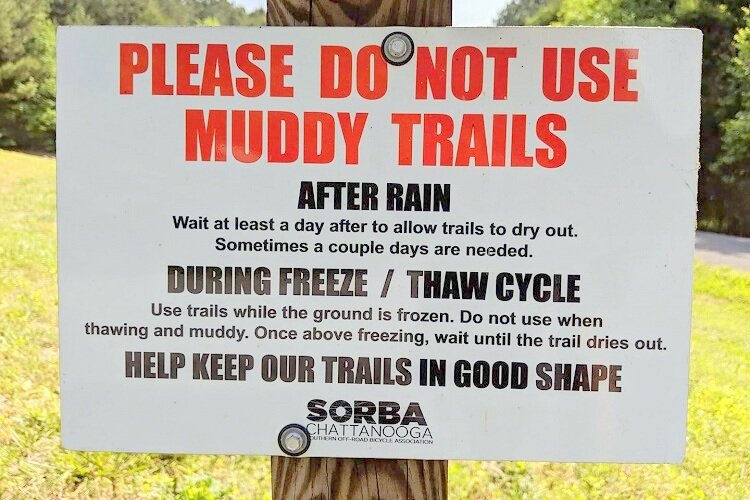 A sign warning cyclists to stay off the trail during the spring thaw.