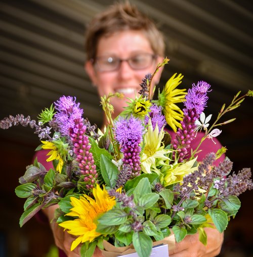 Michigan Flower Growers' Cooperative co-owner Amanda Maurmann arranges flowers.