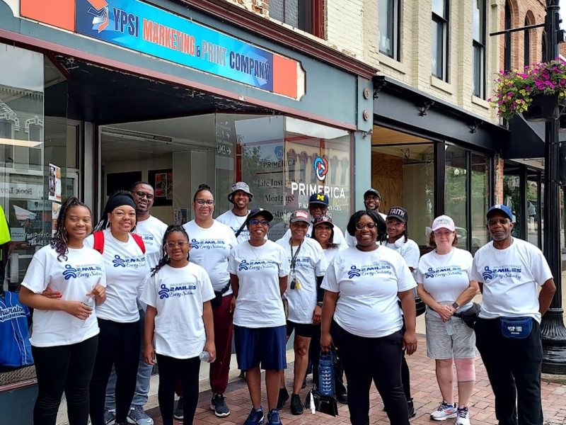 A Walk With Friends group prepares to set out on a two-mile walk around Ypsilanti on June 21, 2025.