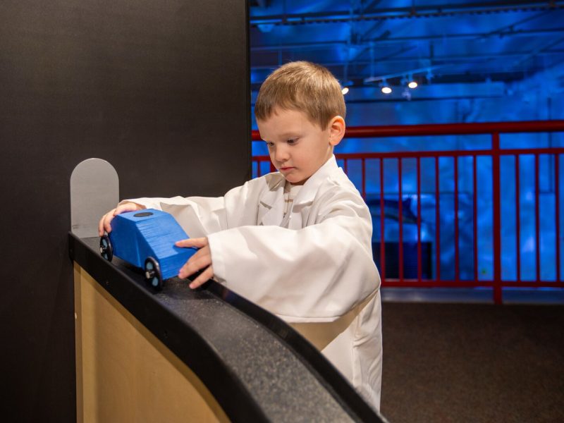A child tests a toy car in the Mobilab exhibit at the Ann Arbor Hands-On Museum.