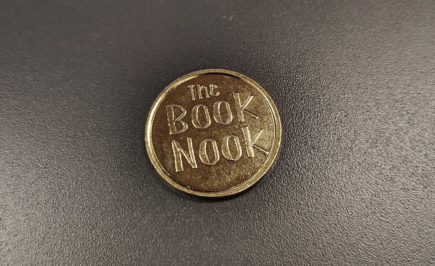 A token to use at a book vending machine.