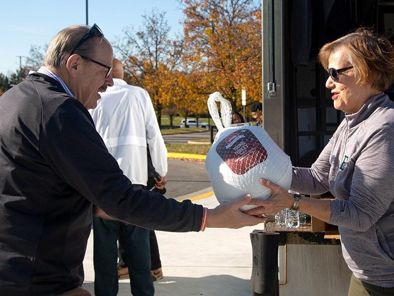 EMU President James Smith and "Thankful For You" event planning committee member Connie Ruhl-Smith at last year's drive-through Thanksgiving meal giveaway.