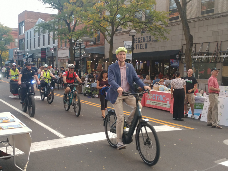 Ann Arbor Mayor Christopher Taylor leads a bike parade at the 2023 Green Fair.