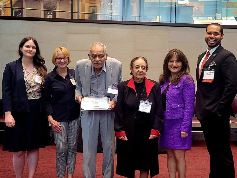 Shawkey and Sanaa Ghobrial, at center, receive the Michigan Community Action Award for Volunteer Service.