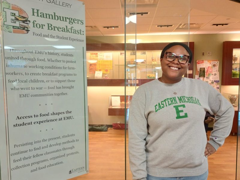 EMU historic preservation student Akaiia Ridley at "Hamburgers for Breakfast," the current student-created exhibit at McKenny Gallery.