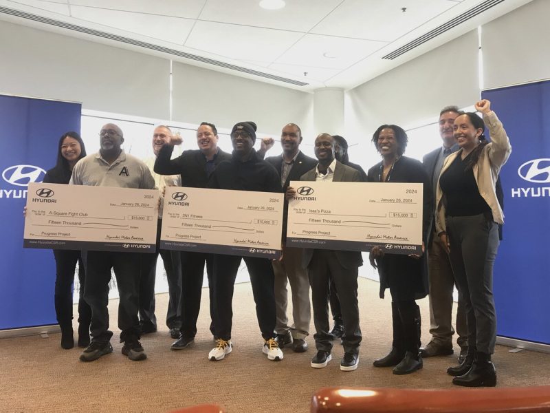 Hyundai staff pose with Progress Project donation recipients.