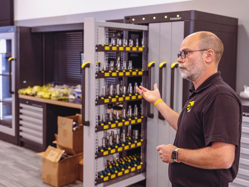 ZOLLER Inc. Training and Development Manager Michael Stepke shows off a piece of equipment that ZOLLER donated to Washtenaw Community College.