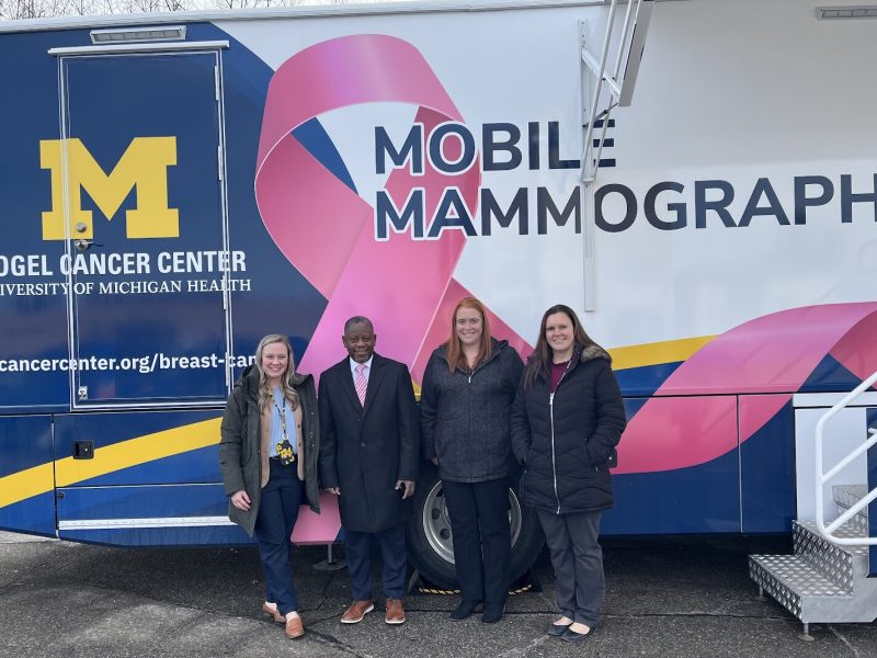 Laura Braid, Tony Denton, Lauren Esch, and Rebecca Hall with the new mobile mammography unit at the University of Michigan Ypsilanti Health Center.