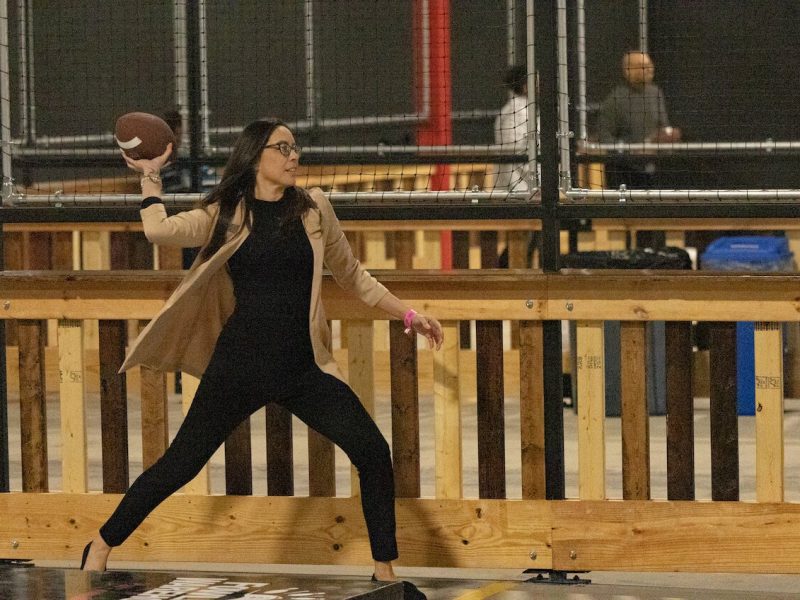 A person fowls at the Ypsi-Ann Arbor Fowling Warehouse. The sport of fowling involves using a football to knock down bowling pins.