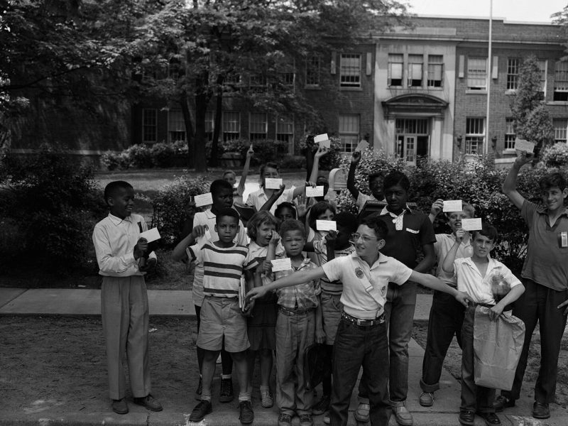 Jones School students hold up their report cards.