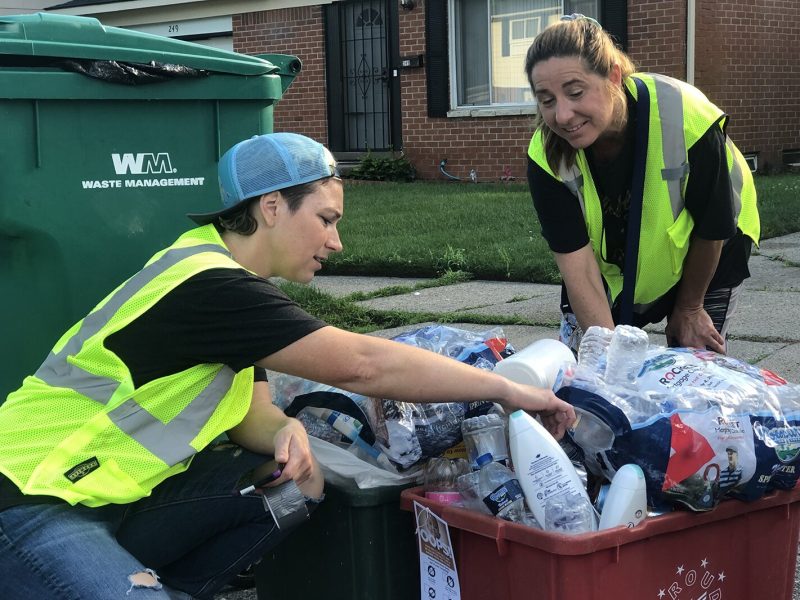 WRRMA-trained cart inspectors Laurena Deak and Julie Cline examine recycling bins in Ypsilanti Township.