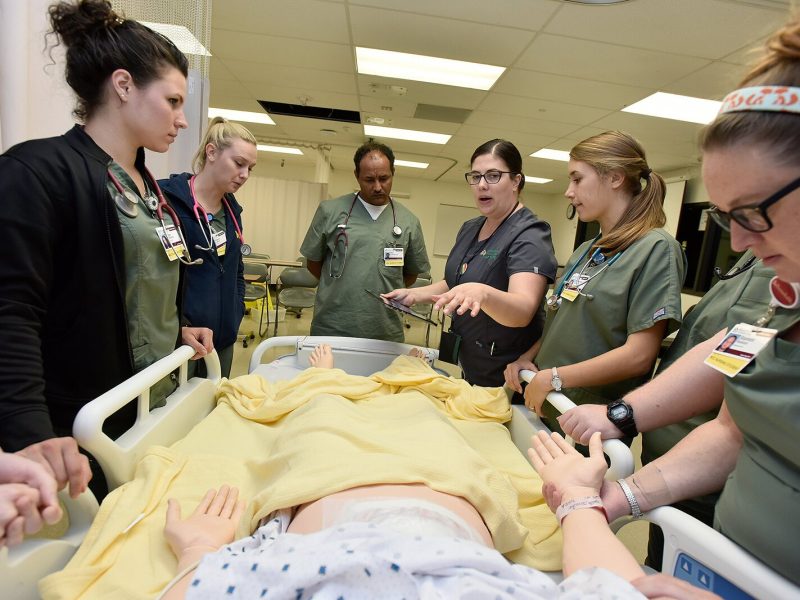 WCC nursing students work with a human simulator.