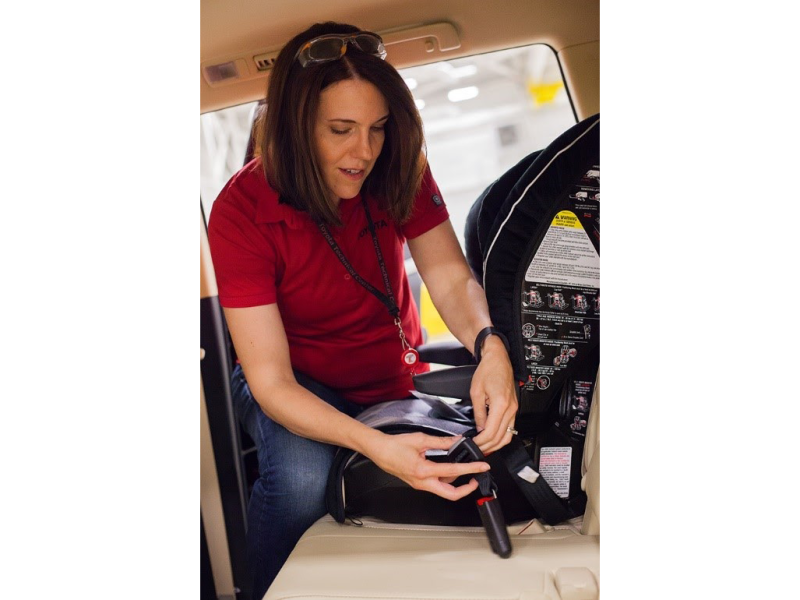 Toyota Principal Engineer Jennifer Pelky installs a car seat.