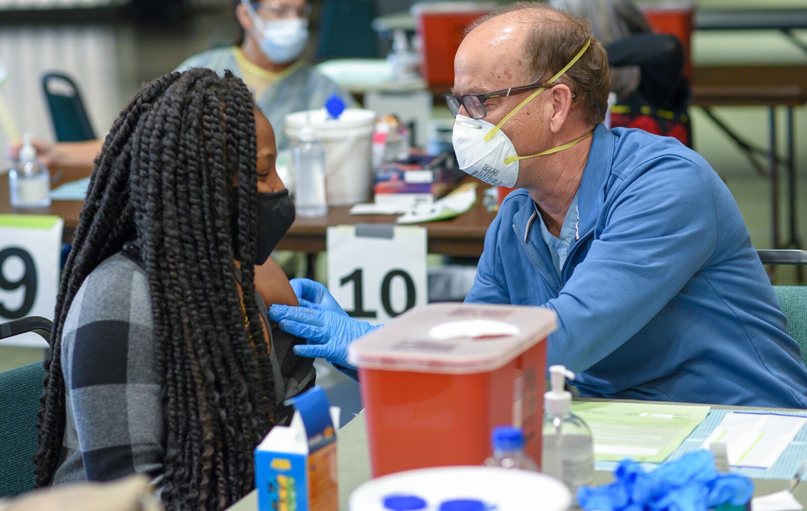 A resident receives a COVID-19 vaccine at the Eastern Michigan University Convocation Center.