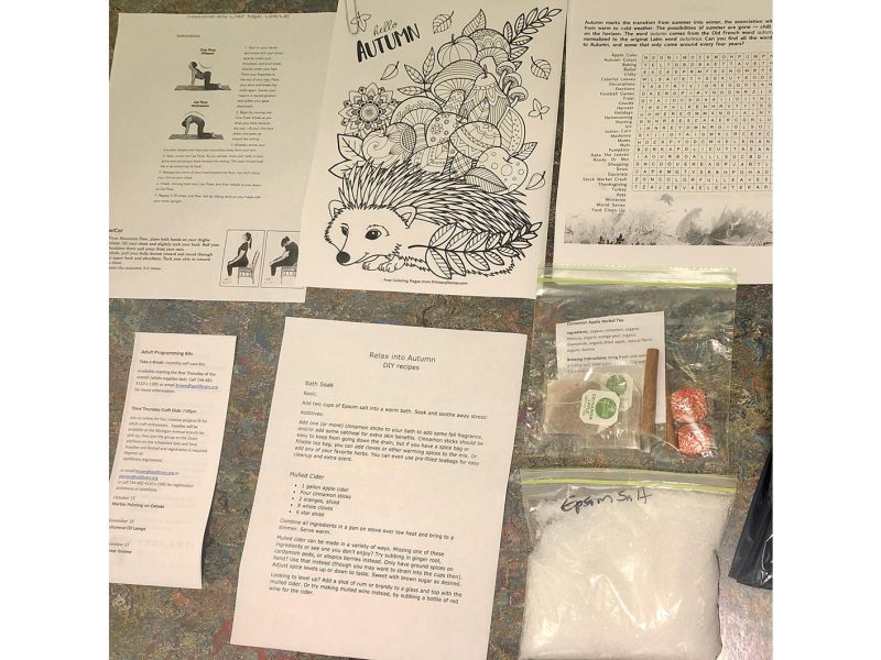 October's apple-themed self-care kit included cinnamon sticks, spiced apple tea, crossword pages, chocolates, recipes, a breathing exercise, and instructions for a yoga pose.