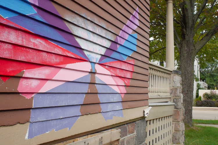 Wings painted on the side of Educate Youth clubhouse.