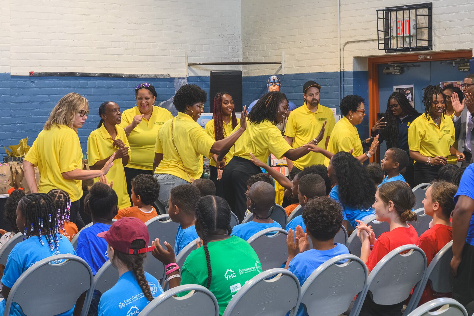 Teachers high-five Parkridge Summer Learning Experience students as they enter.