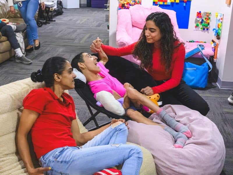 Exceptional Journeys founder Zee Kennedy, at right, interacts with visitors at her nonprofit's Ann Arbor community center.