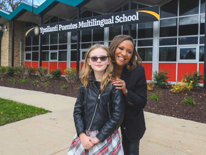 Student Nora McDonald and Principal Celeste Green stand outside Puentes Multilingual School in Ypsilanti, Michigan.