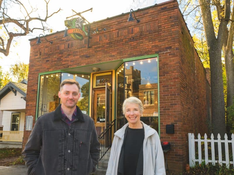 Neighbors for More Neighbors members Greg Matthews and Kit McCullough stand outside Jefferson Market in Ann Arbor's Old West Side.