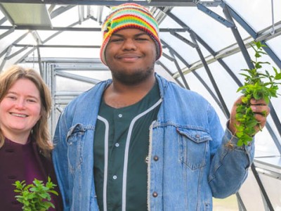 Biology teacher Laurel Wiinikka-Buesser and botany student Elijah Acheampong in the greenhouse at Ypsilanti Community High School.