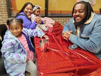 The Lewis family attends a holiday celebration at the Ypsilanti Community Schools Resiliency Center.