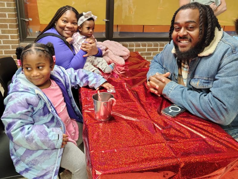The Lewis family attends a holiday celebration at the Ypsilanti Community Schools Resiliency Center.