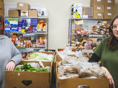 Nesli Erisgen and Amanda Kelly in the food pantry at SOS Community Services.