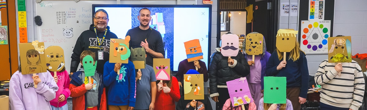 Ypsilanti International Elementary School teacher Gary Quann and Ypsilanti Future History project leader Nick Azzaro (adults in back row) with Quann's class, wearing masks they made in response to the history of an underground venue in Ypsilanti.