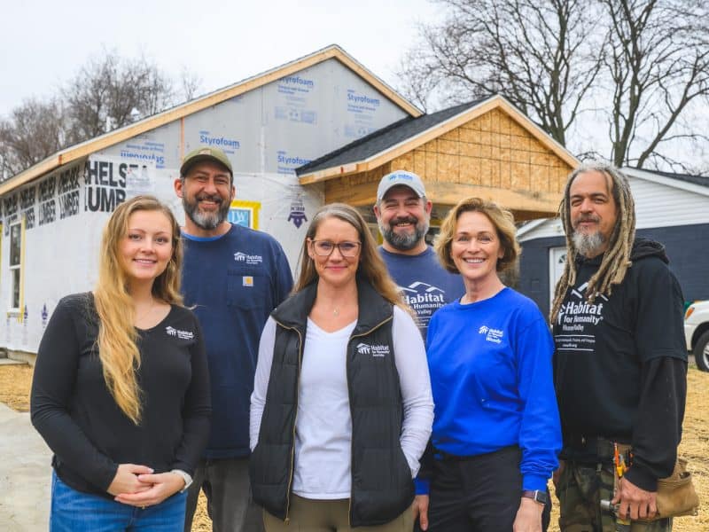 Habitat for Humanity of Huron Valley Home Improvement Program Manager Claire Simpson; Field Construction Superintendent Stevenell Clark; Director of Grants, Corporate, and Faith Giving Leah Tessman; House Leader Peter Shineman; Volunteer Leader Wendy Correll; and House Leader Noeal Johnson at a new Habitat build at 740 Dorset Ave. in Ypsilanti Township.