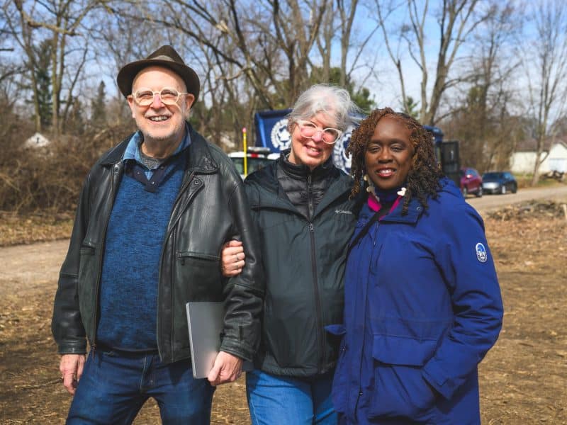 Genealogist Bill Ruddock, Ypsilanti history expert Laura Damschroder, and African American Cultural and Historical Museum of Washtenaw County Board Chair Debby Covington at Woodlawn Cemetery in Ypsilanti Township.