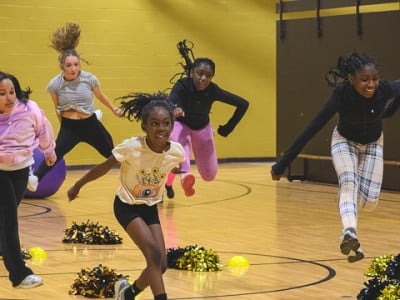 Young people participate in a cheerleading drill organized by Ypsilanti Community - The Village.
