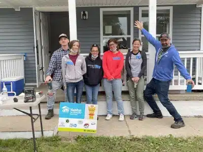 Volunteers show off a home built through Habitat for Humanity of Huron Valley's "House That Beer Built" campaign.