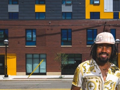 Martez Claybren stands in front of Dunbar Towers in Ann Arbor, where he lives. Dunbar Towers is one of several affordable housing projects supported by the city's Affordable Housing Millage.