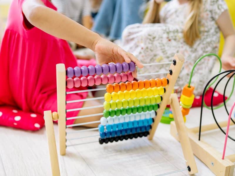 Two girls play at a preschool.